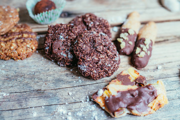 Traditional homemade Christmas cookies: Variety of sweet European cookies on rustic wooden desk, powdered sugar.