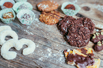 Traditional homemade Christmas cookies: Variety of sweet European cookies on rustic wooden desk, powdered sugar.