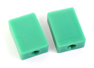 Rubber or silicone molds are used to inject green wax to produce a large amount of jewelry in a jewelry factory placed on a white background.