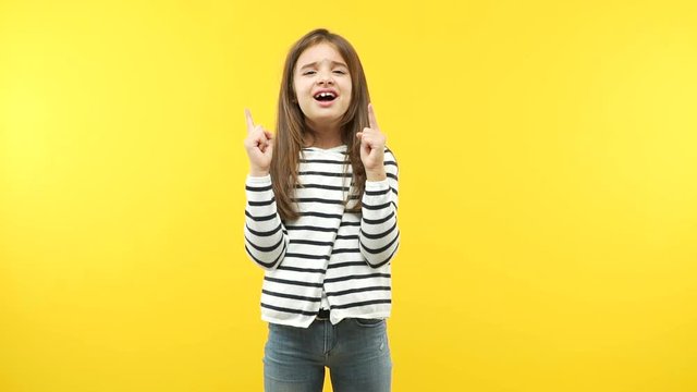 Funny little child girl pointing up