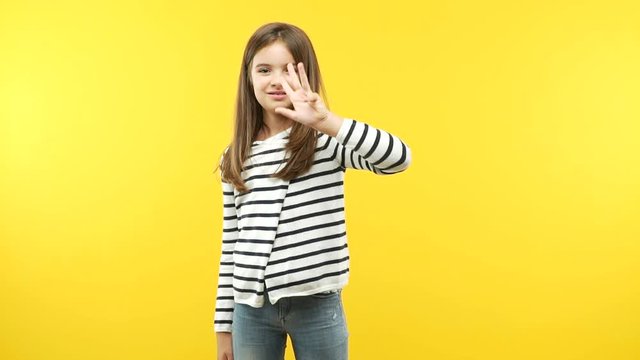 Funny little child girl showing number six