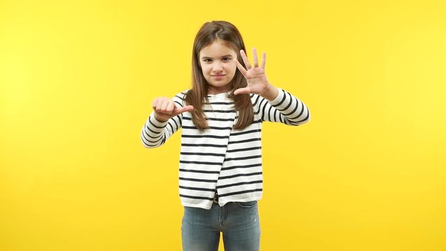 Funny little child girl showing number eight