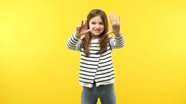 Funny little child girl showing number ten