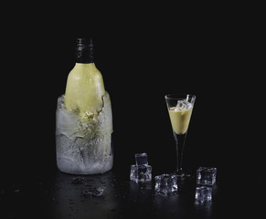 Close up shot of a refreshing cocktail and ice cubes isolated on a black background