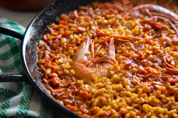 Traditional spanish paella with red prawns.