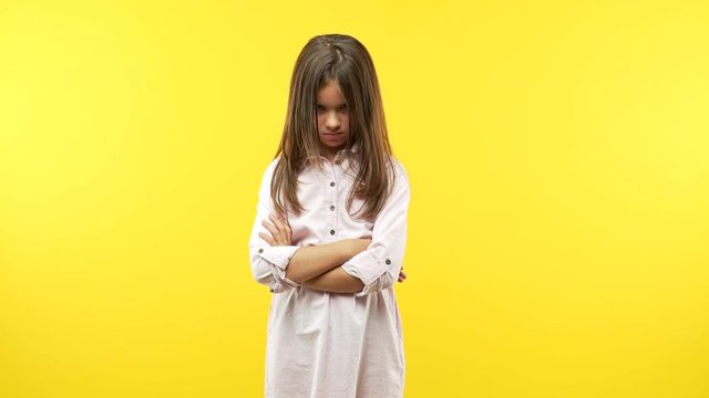 Funny little child girl with arms crossed
