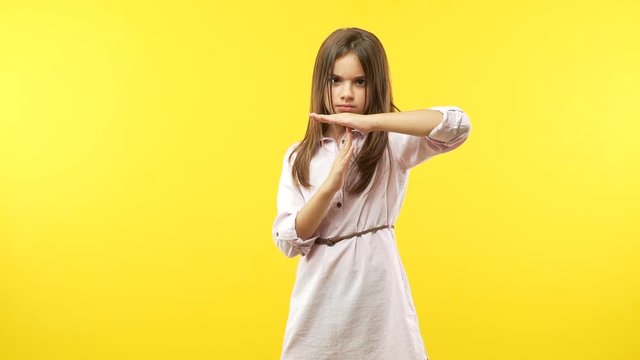 Funny little child girl making a timeout gesture