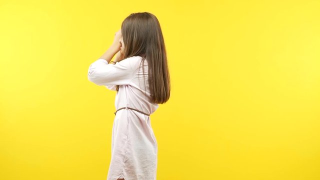 Funny little child girl making the gesture of a spyglass
