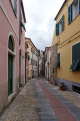 Fototapeta na wymiar Typical Italian narrow street, Diano Castello ancient village, Province of Imperia, Italy