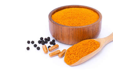 curcumin powder, Curcuma capsules and black peppercorns isolated on white background. 