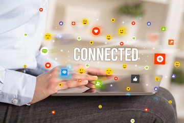 Close up of business person playing multimedia with social media icons and CONNECTED inscription