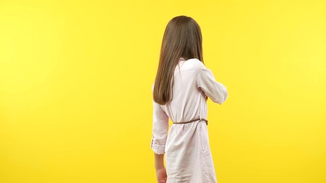 Funny little child girl keeping a secret or asking for silence