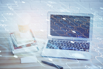 Double exposure of desktop computer and technology theme hologram. Concept of software development.