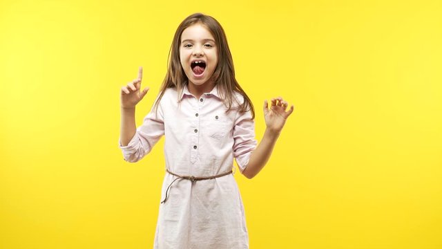 Funny little child girl celebrating a victory or success