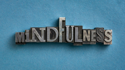 mindfulness word abstract or banner - awareness concept - text in vintage letterpress metal type against blue textured paper