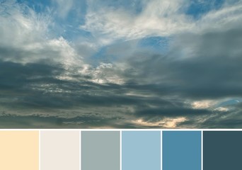 Beautiful dramatic gray clouds in the blue sky at pink sunset. Shades and tones of pink and blue...