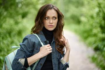 Beautiful young woman in the park. Portrait of a pretty girl