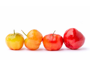 Closeup raw and ripe fresh organic small red   acerola cherry fruit ( Malpighia Glabra ) isolated on white background .