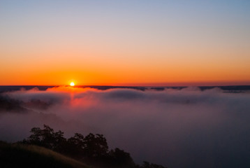 Sunrise over the cliff.
morning haze at dawn on a cliff in summer.