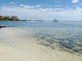 Tropical landscape with calm turquoise waters of the Caribbean Sea with pleasure boats and...