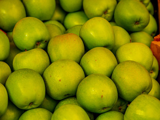 background of green apples on sale at the local market