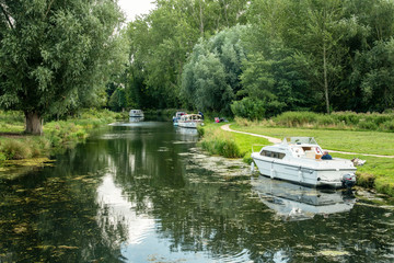 A lovely view looking down river from Horstead mill
with boats moored up on a summers day in norfolk  england