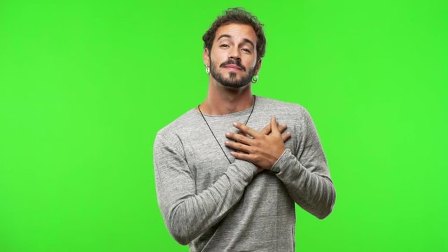 young man on chroma green screen doing a romantic gesture