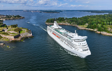 The cruise ferry is departing from Helsinki and moving near the Suomenlinna island, Finland.