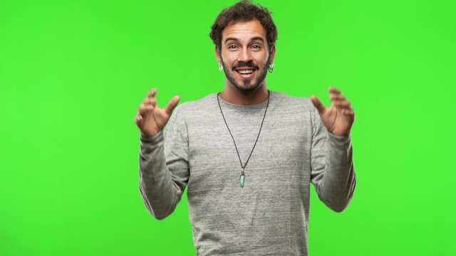 young man on chroma green screen celebrating a victory or success