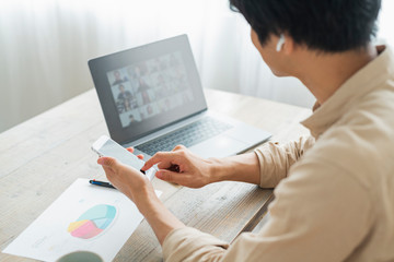 One man working remotely and a cat.