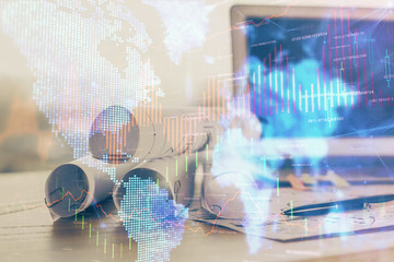 Financial chart drawing and table with computer on background. Double exposure. Concept of international markets.