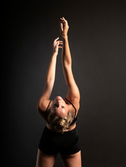 Fototapeta na wymiar Ballerina dance in studio, black background