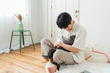 One man working remotely and a cat.