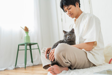 One man working remotely and a cat.