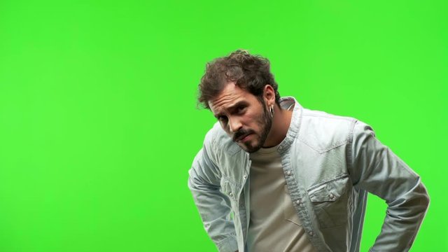 young man on chroma green screen scolding someone very angry
