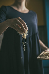 Hand with cheese. Preparing of pizza at the home. Cheese for the homemade pizza. 
Pizza time.
