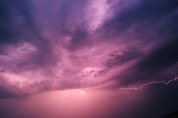 Lightning and storm clouds in the night sky over the sea