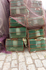 Fototapeta na wymiar Fishing pots netted boxes waiting at waiting at the fishing port