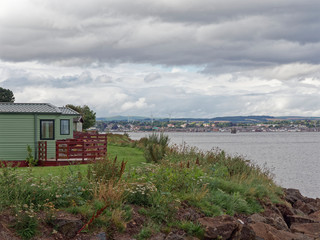Looking to the South West from the Tayport Links caravan Park across the Tay Estuary to Broughty Ferry on a wet overcast day in August.