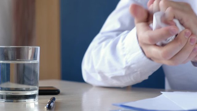 Disgruntled aggressive boss slams his fist on the table and crumples documents