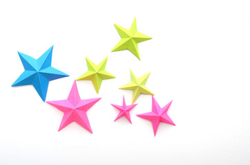 Origami folding stars on white