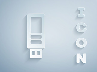 Paper cut USB flash drive icon isolated on grey background. Paper art style. Vector.