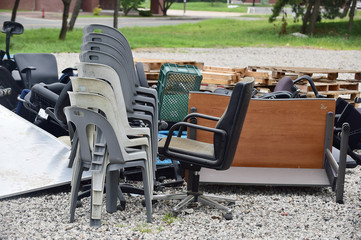 Piles of discarded chairs and furniture rubbish