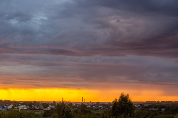 Obraz premium Very beautiful sunset in the city or village. Pink-orange sky with clouds.