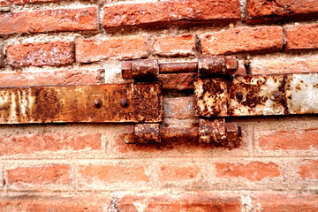 old iron tying crumbling brick structure