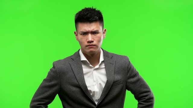 Young chinese business man scolding someone very angry