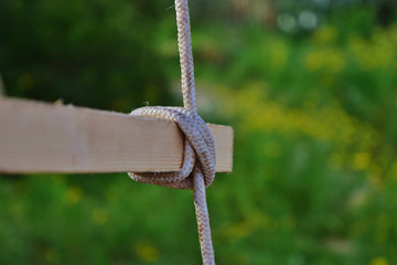 Selective focus shot of clove hitch knot on blur green background