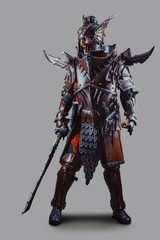 Powerful knight in armor with the sword. Isolated over grey background.