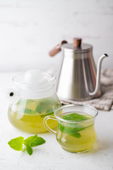 green hot mint tea in glass cup