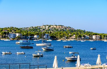 Fototapeta na wymiar View on the mediterranean sea with boats, sailboats, mountains, blue sky. Santa Ponsa, Majorca, (Mallorca), Spain